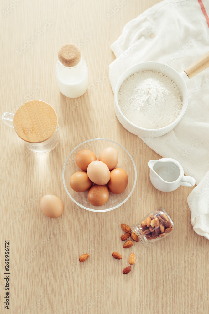 recipe ingredients : eggs, flour, milk, almonds, banana on white background recipe ingredients : eggs, flour, milk, almonds, banana on white background