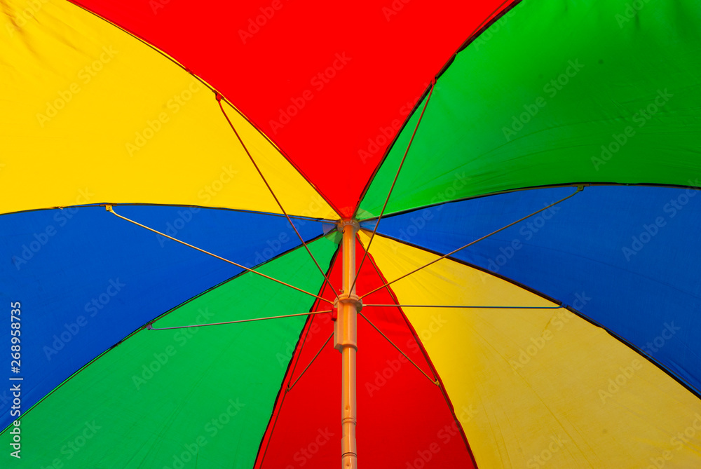 Looking up into the colorful sunshade - rainbow colors - summer feeling