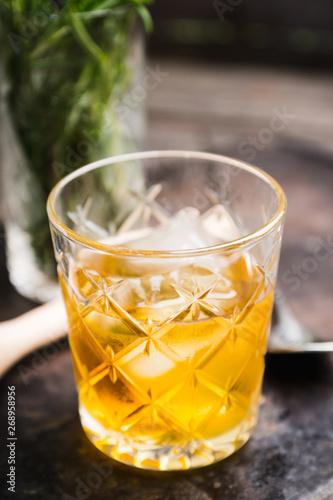 Old fahioned cocktail on the rustic background. Selective focus. Shallow depth of field.