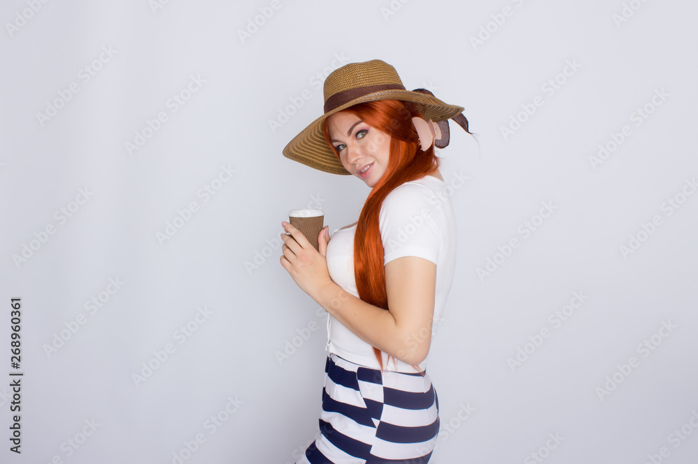Redhead woman drinking coffee from paper cup Redhead woman drinking coffee from paper cup
