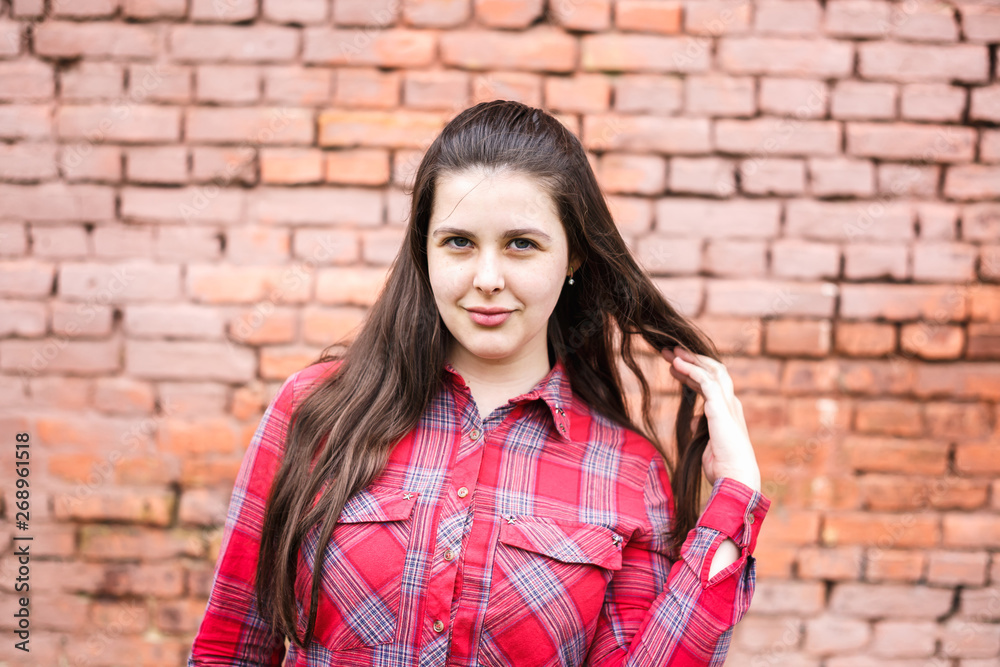close up portrait of big plus size beautiful stylish kid girl near pink brick wall as background close up portrait of big plus size beautiful stylish kid girl near pink brick wall as background