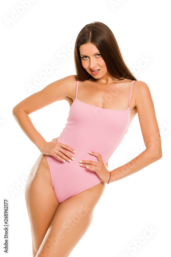 Young lady in one piece swimsuit and long hair posing on white background