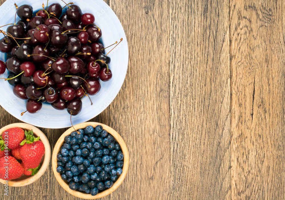 Fresh Summer Berries on Rustic Wooden Background Fresh Summer Berries on Rustic Wooden Background
