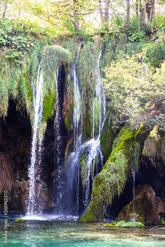 Water that falls from a large waterfall over stone slopes, Plitvice Lakes