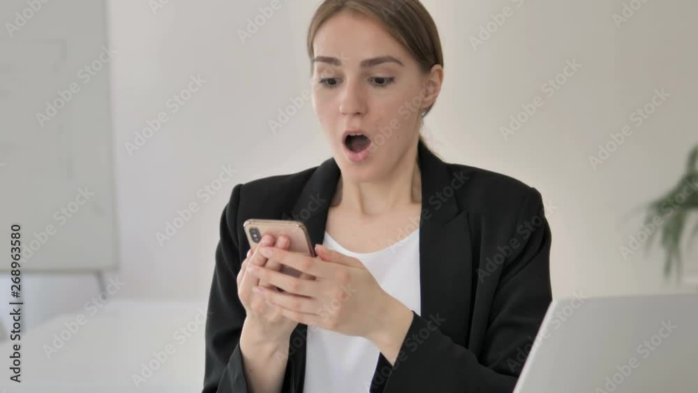 Shocked Young Businesswoman Using Smartphone Shocked Young Businesswoman Using Smartphone