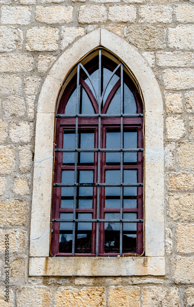 Window in the wall of an old building in Dubrovnik. Window in the wall of an old building in Dubrovnik.