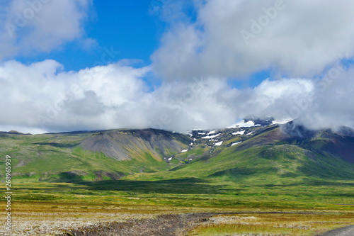 Snaefellsjökull illuminated by the evening light and embraced by clouds photo