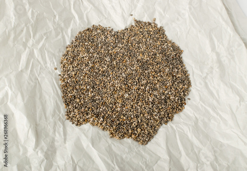 Pile of Chia Seeds in Wrapping Parchment Paper © ange1011