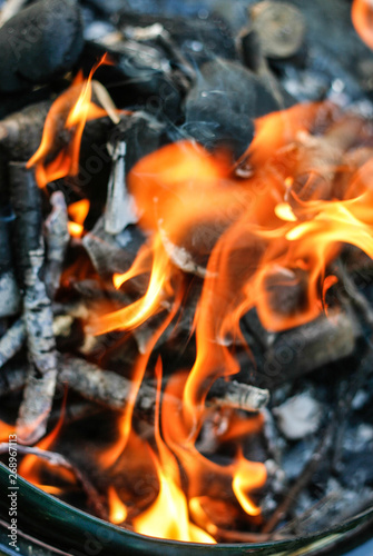 fire burning inside a charcoal grill, close up