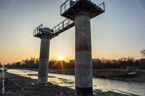 The pillars of the bridge under construction at sunset photo
