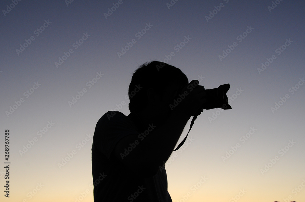 silhouette of man with camera