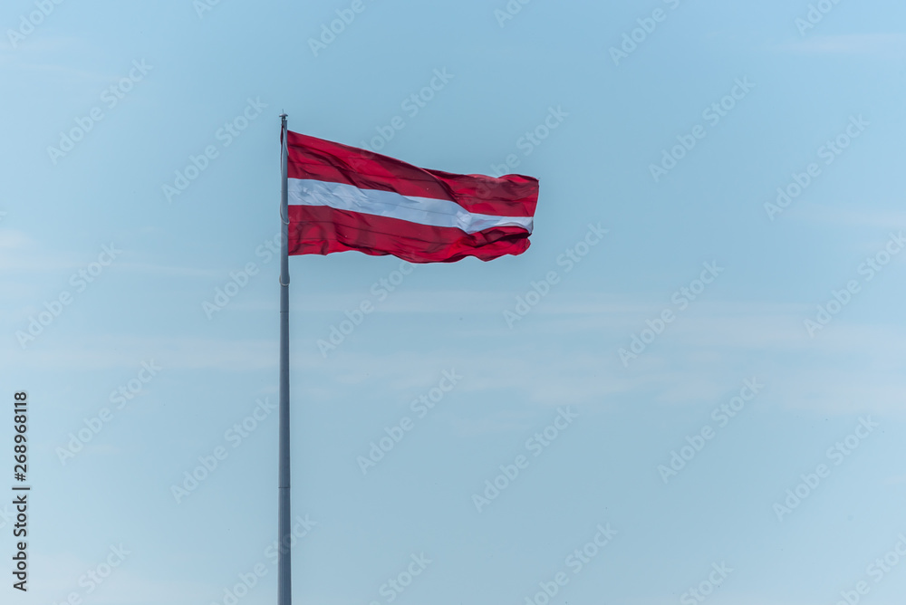Latvian Flag on a Windy Day with a Sunny Sky Latvian Flag on a Windy Day with a Sunny Sky