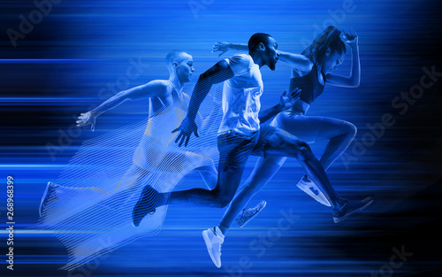 Young african-american and caucasian men and woman running isolated on blue studio background. Silhouette of jogging athletes with shadows in neon light. Movement or motion. Creative collage. © master1305