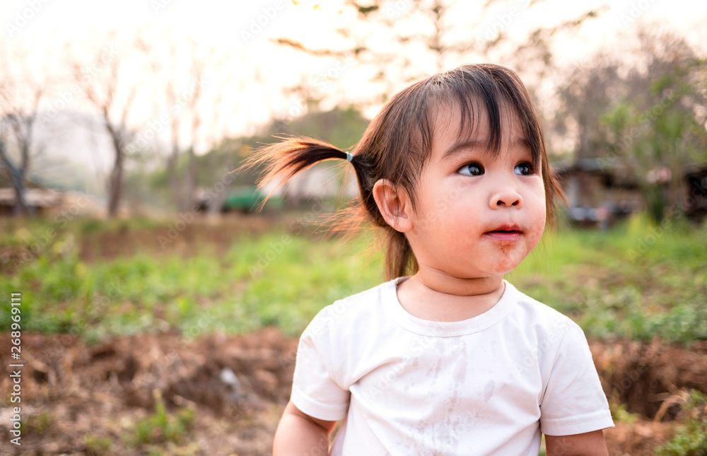 Asian little girl testing the taste of fresh mulberry balls the beginning in the garden, First time to eating. Playing is learn to children. Asian little girl testing the taste of fresh mulberry balls the beginning in the garden, First time to eating. Playing is learn to children.