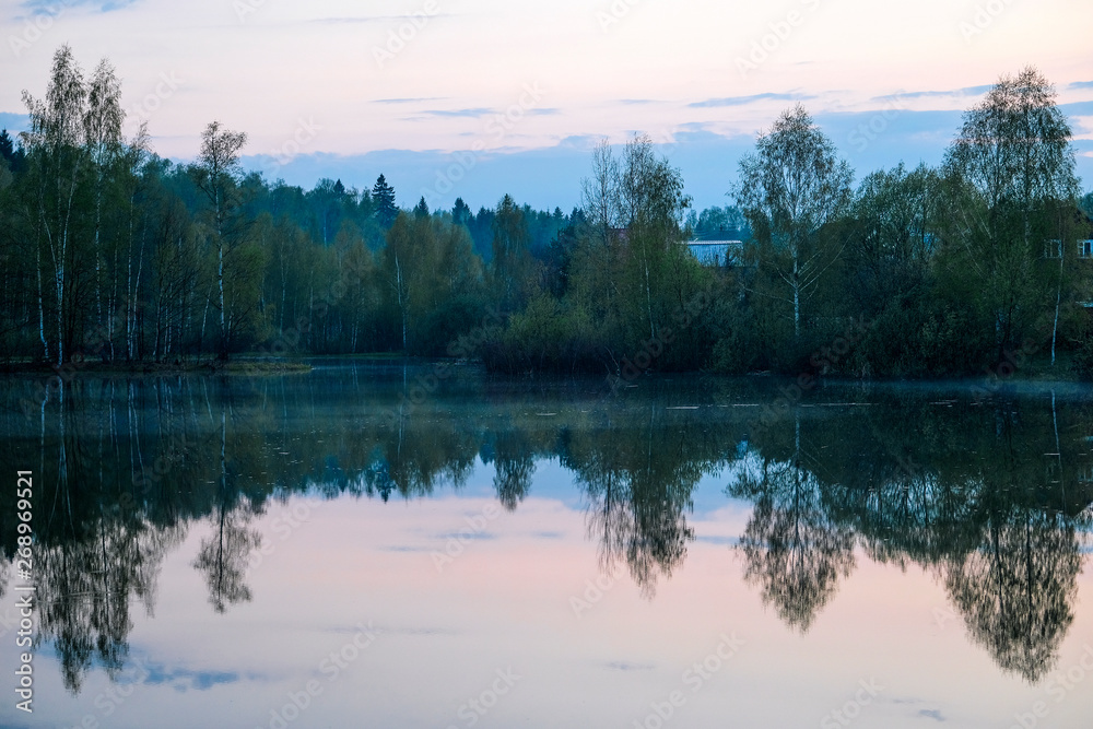 Landscape with the image of village on lake Seliger in Russia