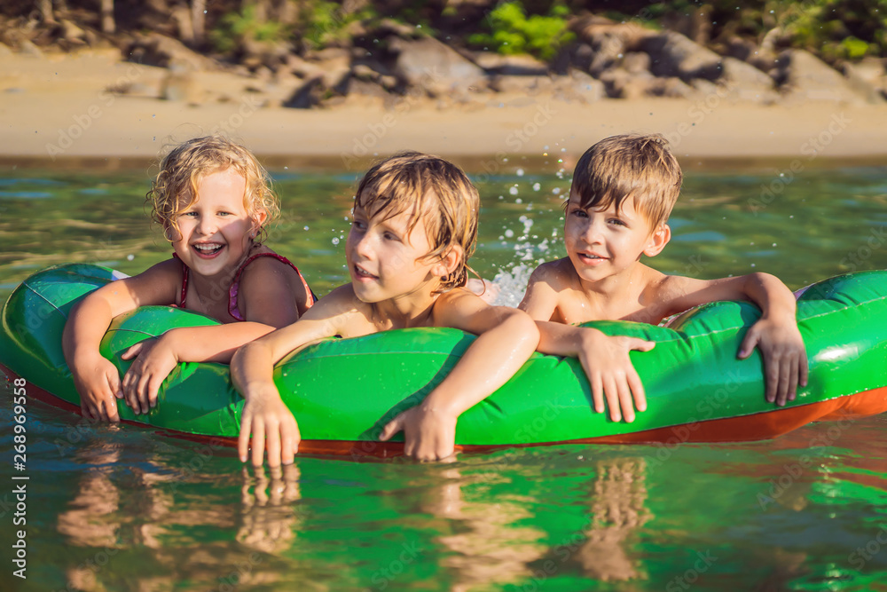 Children swim in the sea on an inflatable mattress and have fun Stock ...
