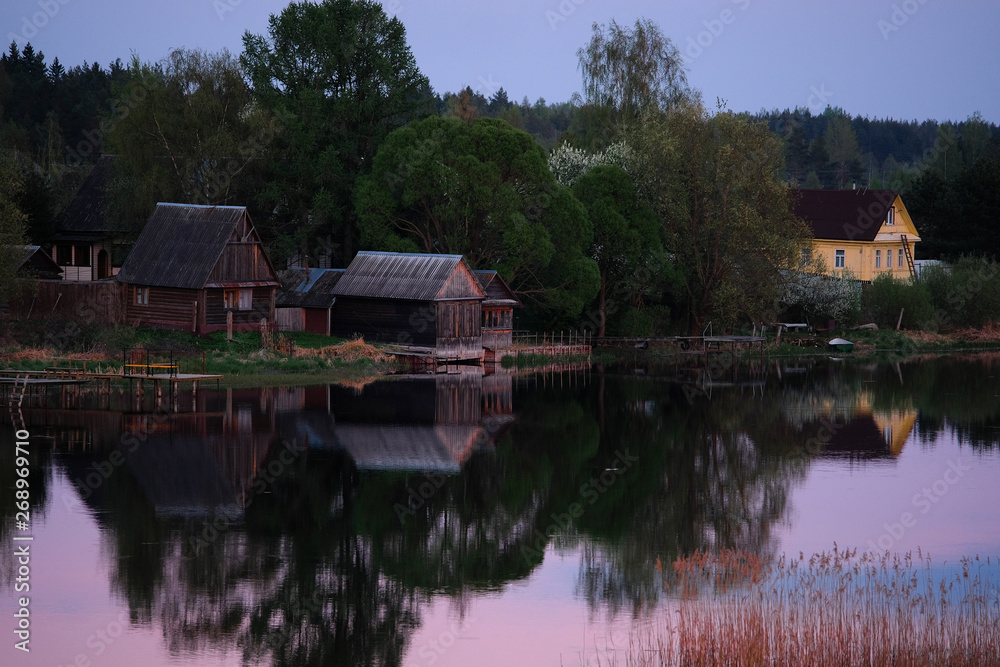 Landscape with the image of village on lake Seliger in Russia