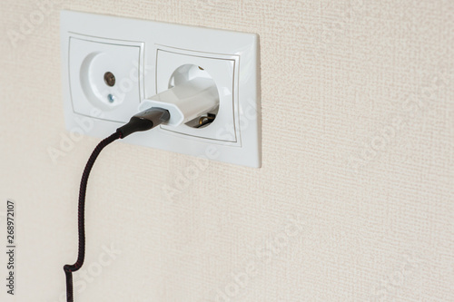 adapter for smartphone charging in on socket wall © Kiryakova Anna