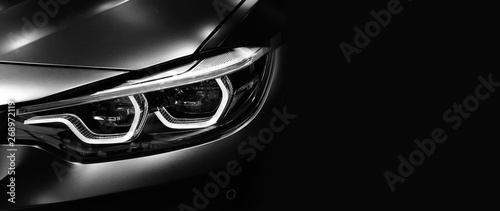 Detail on one of the LED headlights modern car on black background © I Viewfinder
