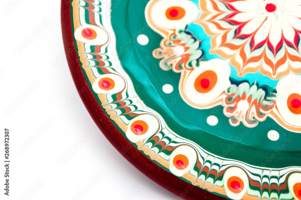 Fototapeta premium Bulgarian traditional plate, souvenir decorated dish with Balkan floral ornament. Isolated on white background.