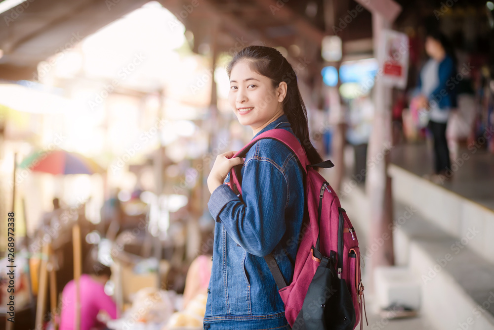 Young asian girl walking at Dumonoe saduak floating market, Thailand Young asian girl walking at Dumonoe saduak floating market, Thailand