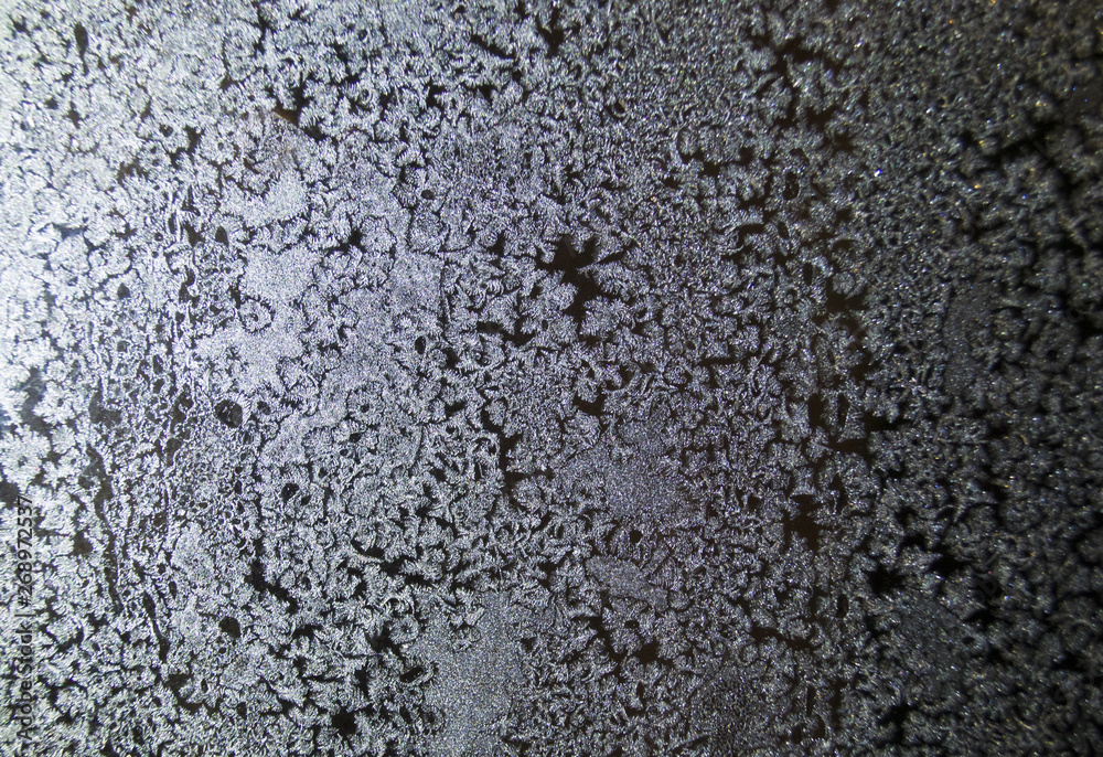 Crystal patterns on the glass in the frosty winter Crystal patterns on the glass in the frosty winter