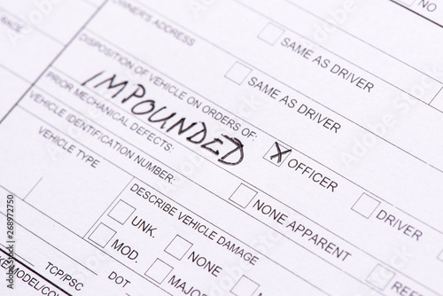 A close up of a traffic collision report where a car was impounded. photo