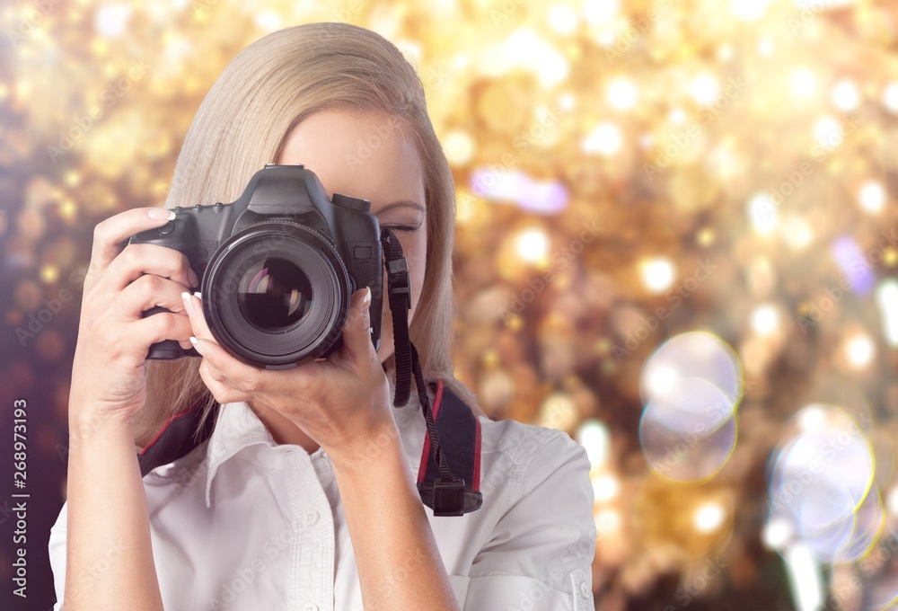 A young woman takes photos with a professional camera