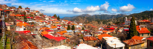 Pedoulas cozy village in Troodos mountains, Cyprus, panoramic view. Scenic cityscape with tiled roofs and blue sky, Marathasa valley, Lefkosia (Nicosia) district photo