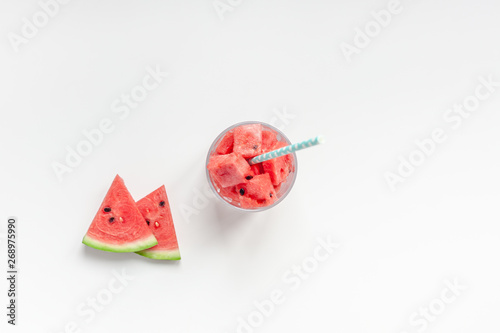Crushed watermelon in glass on white background