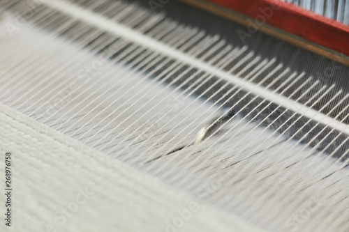Obraz na płótnie Textile factory machine weaving close up