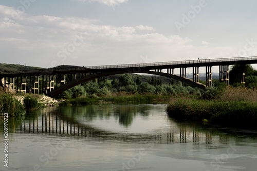 Muddy river flowing under bridge. Redriver in Turkey © shodography