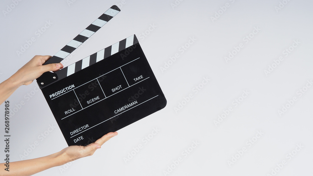 Hands is holding black Clapperboard or movie slate. it use in video production ,film, cinema industry on white background.