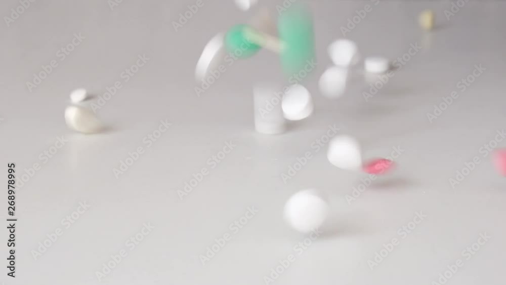 pills pour in slow motion on top. the doctor is eating pills on the table. close-up pills pour in slow motion on top. the doctor is eating pills on the table. close-up