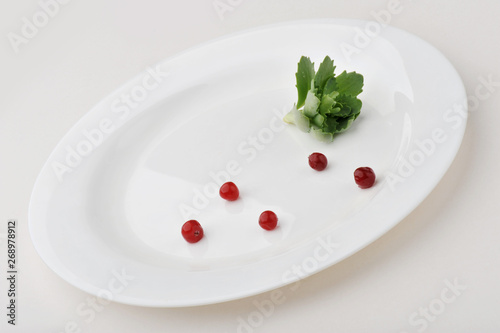 Leaf vegetable on large white plate isolated on white background