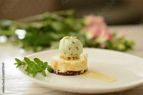 dessert with a ball of pistachio ice cream with flower decor