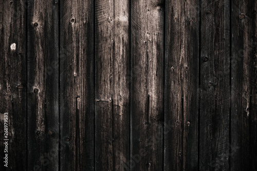 Dirty dark shabby wooden table. Black wooden fence texture background. Wood pattern, surface. Old wall wooden vintage floor. Close-up of wooden black board texture.