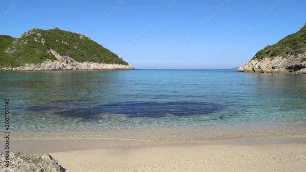 Smooth panning shot of the crystal clear water lapping Porto Timoni beach on the Island of Corfu. Smooth panning shot of the crystal clear water lapping Porto Timoni beach on the Island of Corfu.