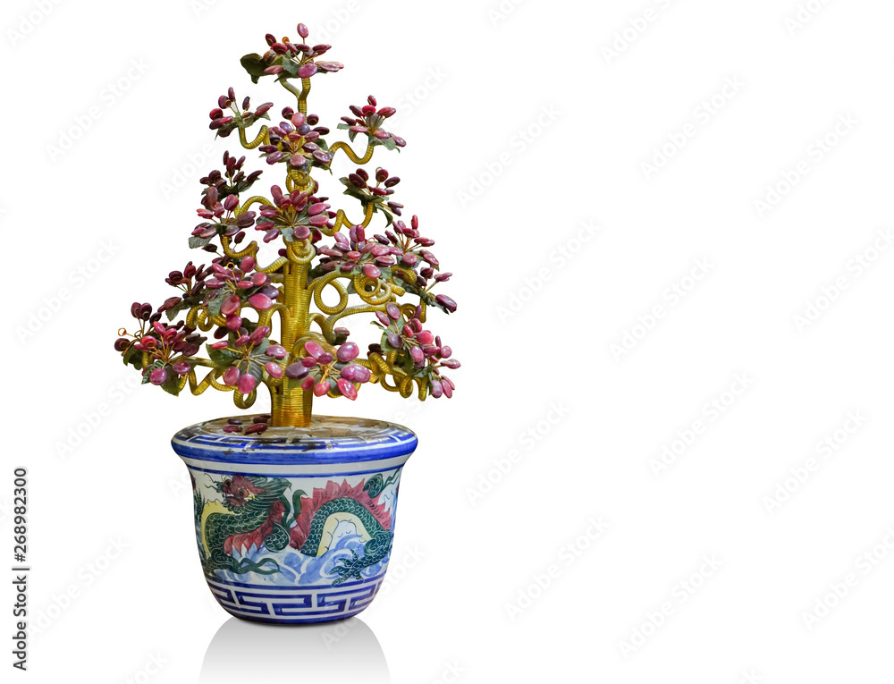 Fototapeta premium Tree made of old jewelry in blue ceramic pot on white background,object background,religion background, copy spac