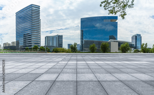 empty pavement and modern buildings in city.