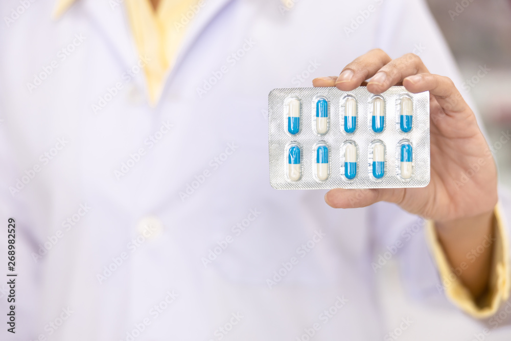 capsule in the women pharmacist hand capsule in the women pharmacist hand