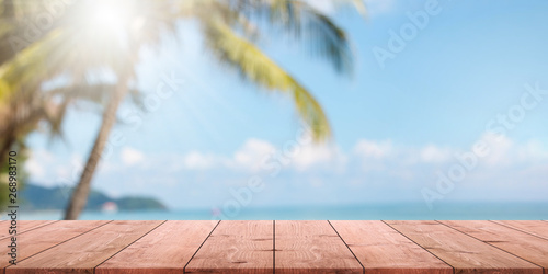Canvas Print Empty wood table top and blurred summer beach with blue sea and sky banner background