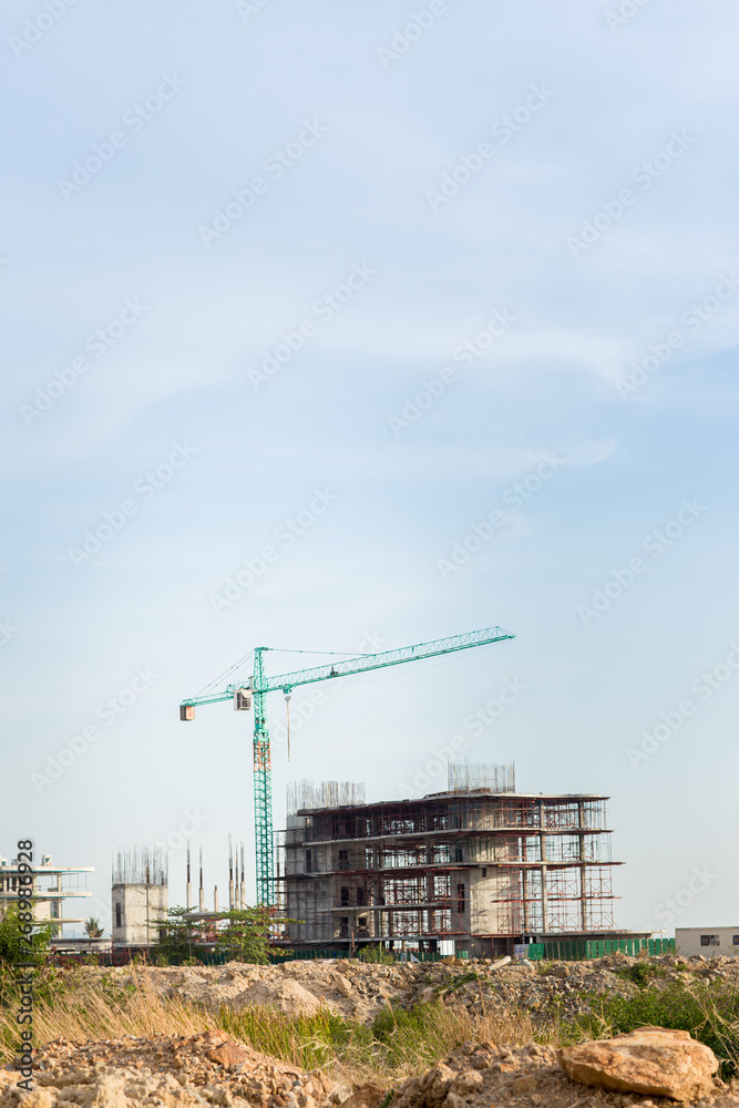 construction site including several cranes working on a building complex. Construction Site, construction machinery,factory construction site including several cranes working on a building complex. Construction Site, construction machinery,factory