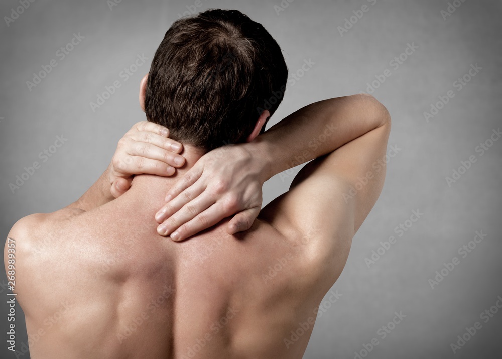 Strong man with neck pain, back view Strong man with neck pain, back view