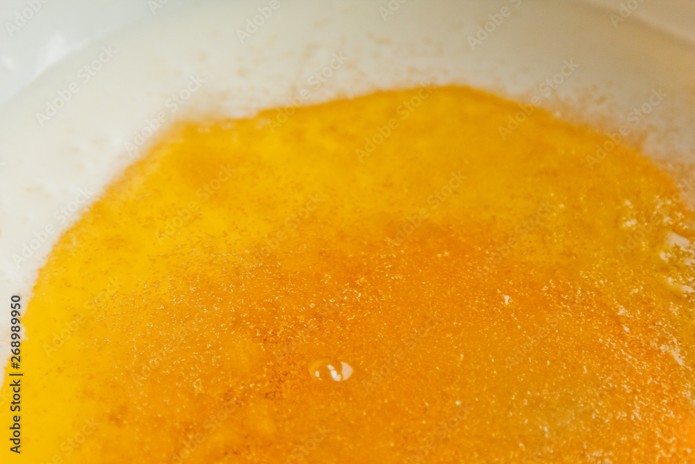 oil poured into milk in a metal bowl. dough preparation stage. recipe puff pastry. baking ingredients closeup top view oil poured into milk in a metal bowl. dough preparation stage. recipe puff pastry. baking ingredients closeup top view