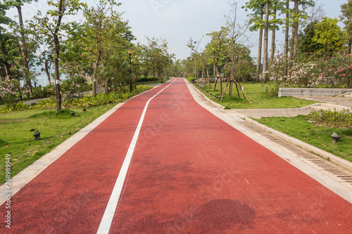 Longitudinal red asphalt trails in parks