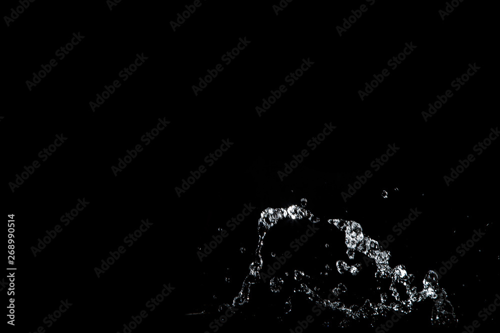 water splash drop to the ground on Black background . Close up of splash of water forming explode shape