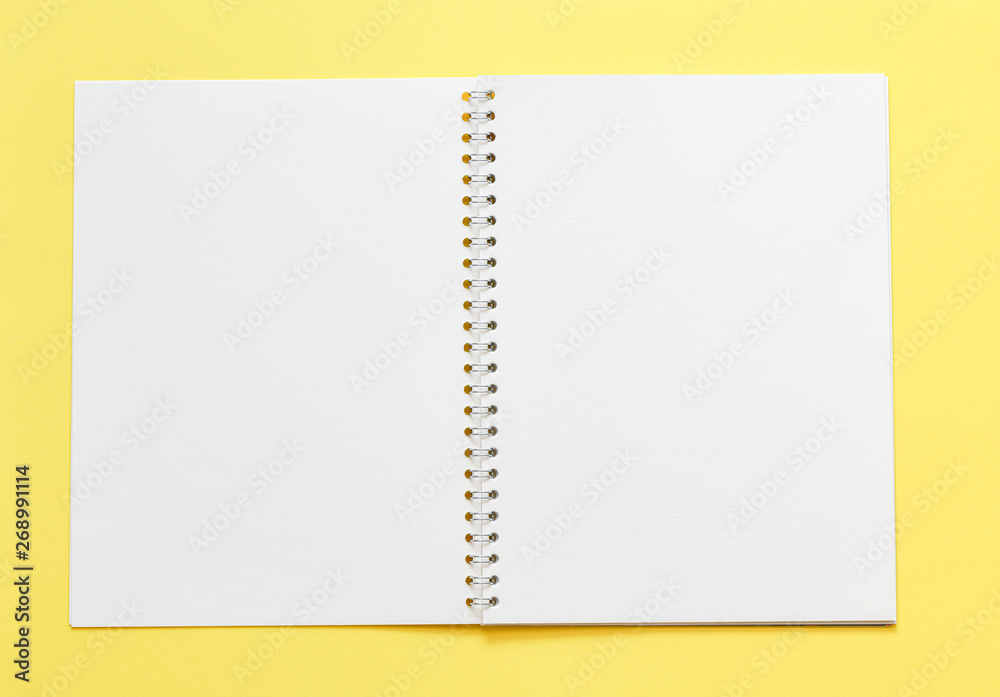 Top view, empty notebook on a yellow background Top view, empty notebook on a yellow background