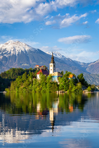 Church on island reflected in waters of Bled Lake photo