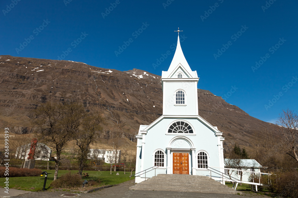 White church in a small village in the fjords of Iceland